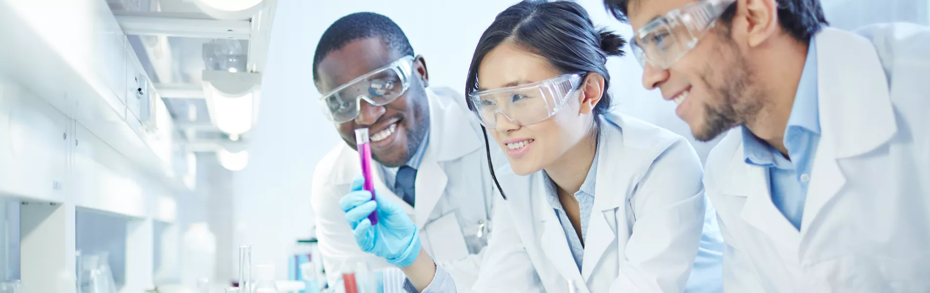 Students in lab coats collaborating